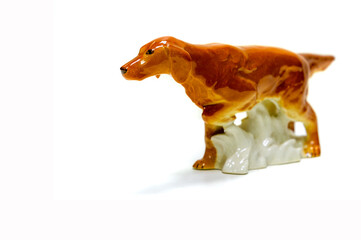 Antiques, art, collectibles. Swap meet. Isolated over white background. figurine of a dog American Foxhound. These are graceful dogs, capable of quickly developing great speed. glazed ceramics.