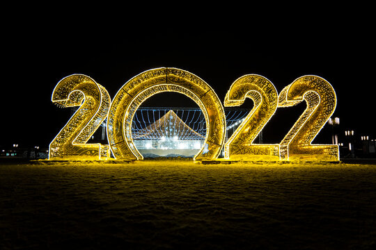 Happy New Year 2022. Sparkling burning numbers Year 2022 with on black background. christmas street decorations. Beautiful design element.