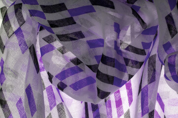 Texture. Background. Template. White silk fabric with purple and black geometric rhombus shapes. violet, violaceous