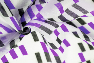 Texture. Background. Template. White silk fabric with purple and black geometric rhombus shapes. violet, violaceous