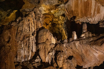 abstract background of stalactites, stalagmites and stalagnates in a cave underground, horizontal