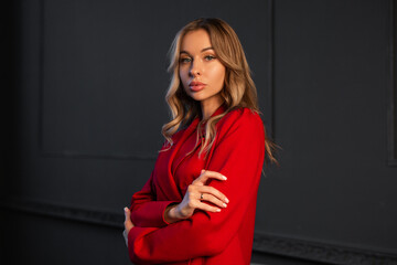 portrait of stylish young woman with makeup in red suit 