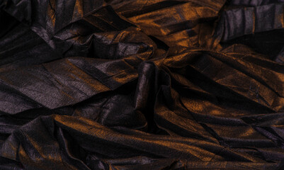 texture. background. template. wallpaper. black silk fabric with yellow golden stripes, wrinkled fabric