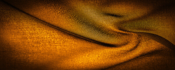 Background texture Dark sepia brown-yellow chiffon silk is a soft transparent fabric with a slight...