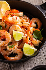 Grilled shrimps with greens and garlic in a pan