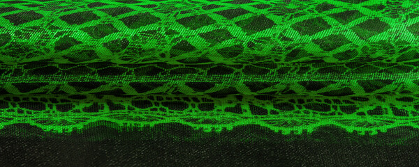 Texture, background, pattern. Emerald green lace fabric, a combination of green with black fabric....