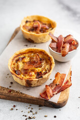 Mini pies with onion and bacon. Hearty pastries