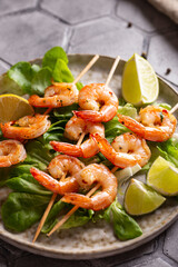 Grille shrimps with salad on a plate