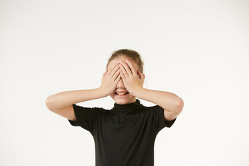 The girl in black clothes on a white background depicts the emotion
