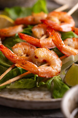 Grille shrimps with salad on a plate