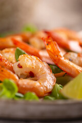 Grille shrimps with salad on a plate