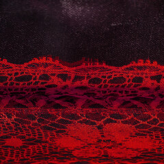 Texture, background, pattern. Ruby red lace fabric, a combination of red with black fabric....