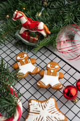 Christmas homemade gingerbread man cookies. Christmas mood. Nobilis branches with bright red balls