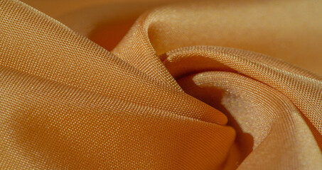 Texture, background, silk fabric, yellow amber. The photo is intended for, interior, imitation of a...