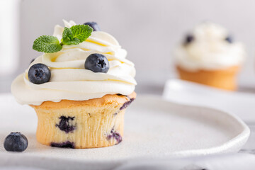 Sweet muffins with blueberries and cheese cream