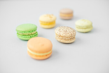 Macaroons on gray background. Beige, brown and yellow and green French macarons. Valentine's Day gift
