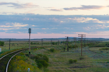 railway, railroad, rail, elevated. steppe prairie veld. is a means of transportation and passengers of trucks moving on rails that are located on the rails of the Great Plains.  The steppe is great.