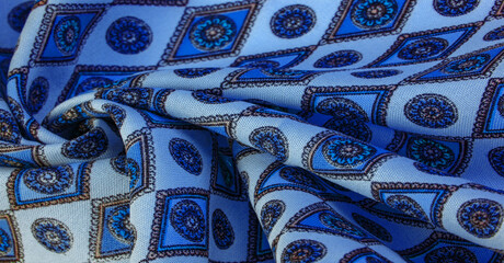 silk fabric in soft blue with a print of rhombuses, squares and medals. Tell a story and make a statement with traditional design work that has charm and value. Texture background pattern