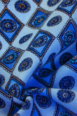 silk fabric in soft blue with a print of rhombuses, squares and medals. Tell a story and make a statement with traditional design work that has charm and value. Texture background pattern