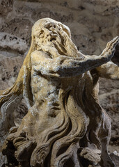 Fototapeta na wymiar Stone sculpture of St. Onuphrius, Rukomysh. Written by Pinzel