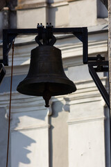 Fototapeta premium Large Church bell hanging outside. Close-up view of metal orthodox church bell