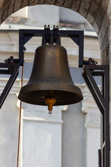 Large Church bell hanging outside. Close-up view of metal orthodox church bell