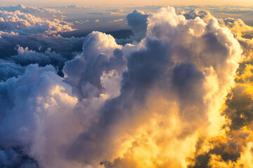 Aerial view above clouds in the sky at sunrise