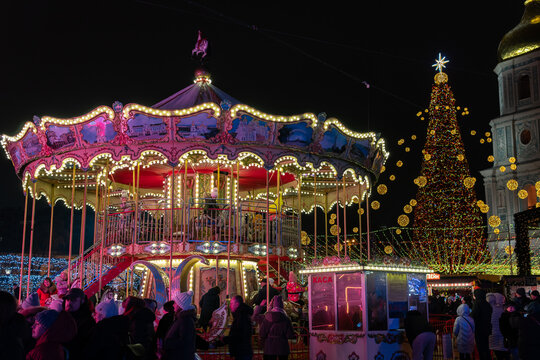 Kyiv (Kiev), Ukraine - December 18, 2021: Decorated main festive  Christmas tree and carrousel on Mykhailivska Square
