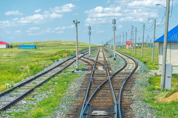 railway, railroad, rail, elevated. steppe prairie veld. is a means of transportation and passengers of trucks moving on rails that are located on the rails of the Great Plains. Kazakhstan  