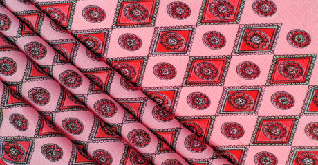 silk fabric of soft red color with a print of rhombuses, squares and medals. Tell a story and make...