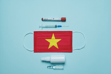 Blood tube for test detection of virus Covid-19 Omicron Variant with positive result, medicine mask with Vietnam flag superimposed and vaccine.  New Variant of the Covid-19 Omicron - 476740054