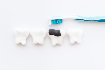 Oral health and care concept - clean teeth models with toothbrush