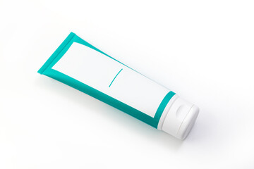 Cosmetic cream green tube. Sskincare cosmetic package. Plastic toothpaste tube. Product in green tubeisolated on white background. Clipping path included.
