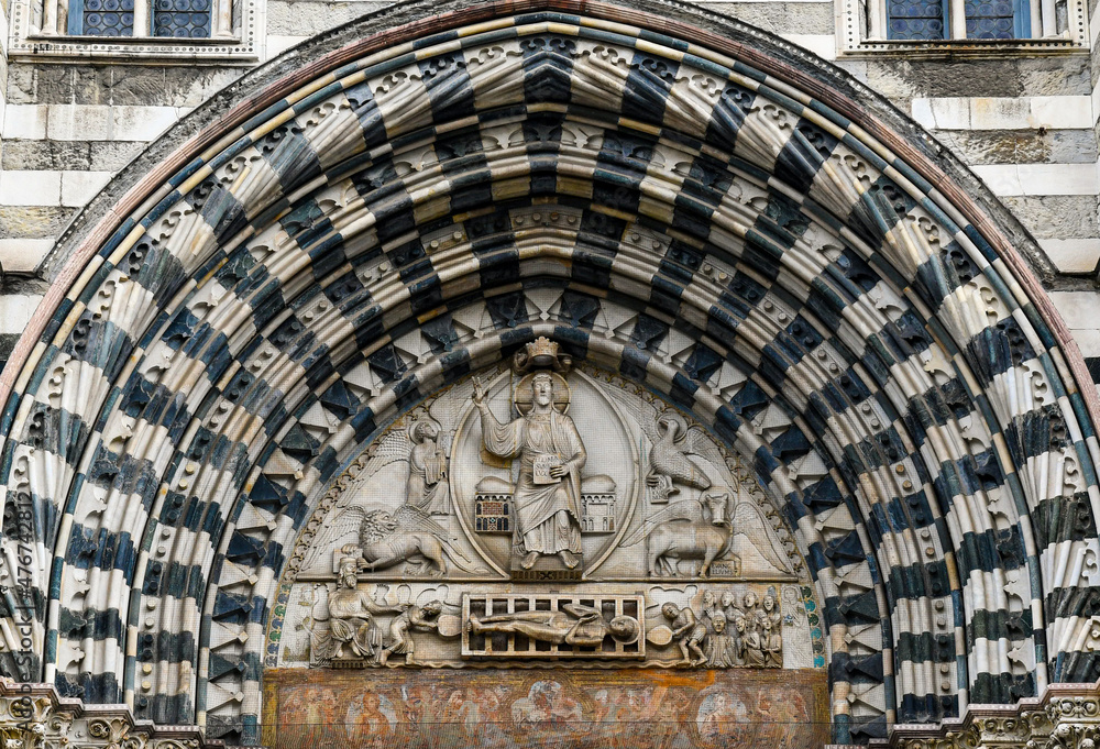 Wall mural Lunette of the central portal of the Cathedral of San Lorenzo with Christ the Judge surrounded by the symbols of the four Evangelists and below, the Martyrdom of San Lorenzo, Genoa, Liguria, Italy