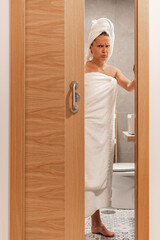 Woman annoyed at being spied on closes bathroom door
