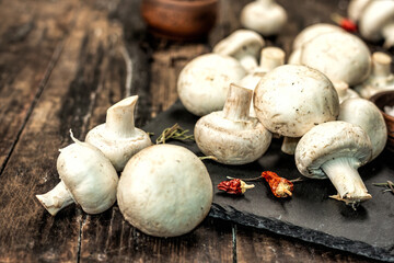 Fresh champignons with spices and herbs. Raw ingredient for cooking vegan food