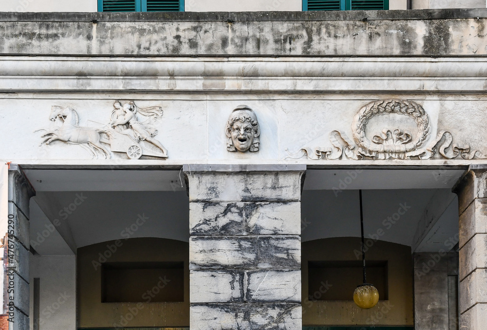 Wall mural detail of the façade of the carlo felice theatre with bas-reliefs and sculptures, in the centre of g