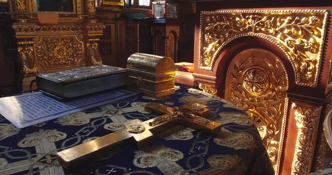 KYIV, UKRAINE � OCTOBER, 02, 2021 Kiev Pechersk Lavra The church utensils are on the table. Books, crucifixion, preparation for the rite of baptism.