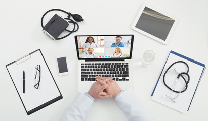 Unrecognizable Doctor Making Video Call Consulting With Diverse Colleagues, Top-View