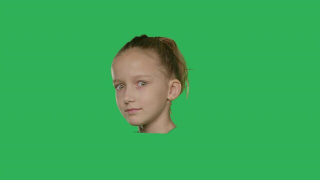 Close-up of head of girl rotate on green screen background, Fun. Chroma Key. Face of young caucasian kid make different emotions . 4K UHD slow motion RAW graded footage