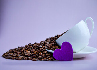 Coffee beans in coffee cup on purple background