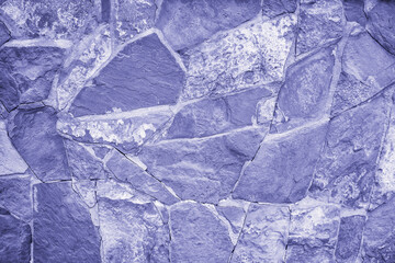 Natural stone wall color 2022 very peri lavender. Concept stone wallpaper, background