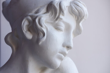 Close-up of a plaster bust of Sappho. Side view, place for text.