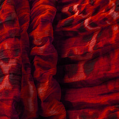 Red cloth. Silk fabric in fine organza with panther print, Crumpled texture. Background. Template.