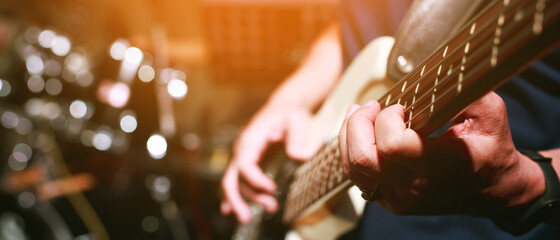 close up hand young man playing electric guitar at recording studio rehearsal base. rock music band. - obrazy, fototapety, plakaty
