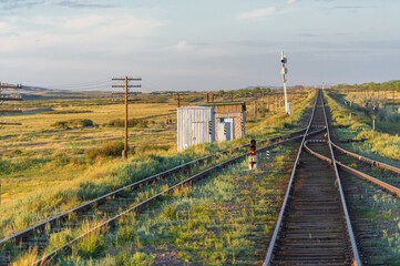 Fototapeta na wymiar railway, railroad, rail, elevated. steppe prairie veld. is a means of transportation and passengers of trucks moving on rails that are located on the rails of the Great Plains. Kazakhstan The steppe 