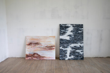 Modern art. View of two expressive paintings in the art studio. The paintings depict natural...