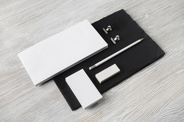 Blank stationery template. Branding mock up for designers portfolios. Blank envelope, business cards, pencil, eraser and clips on stone board.