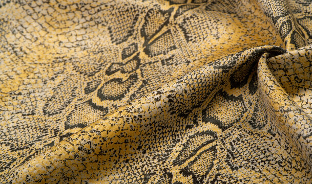 fabric with a pattern of yellow snake skin, African fabric, designer photo - safari in the country of Africa. Texture