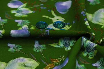 Cotton, green background with a print of bunnies and fruits. The jersey fabric is so named because it was first produced in the Middle Ages on the Channel Island of Jersey.